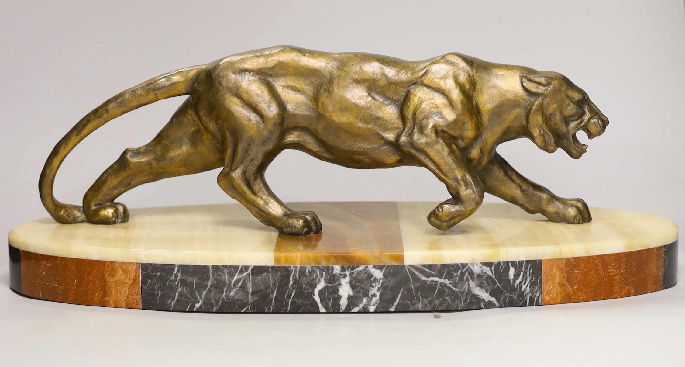 A French Art Deco model of a tiger, on marble base, 56cm long